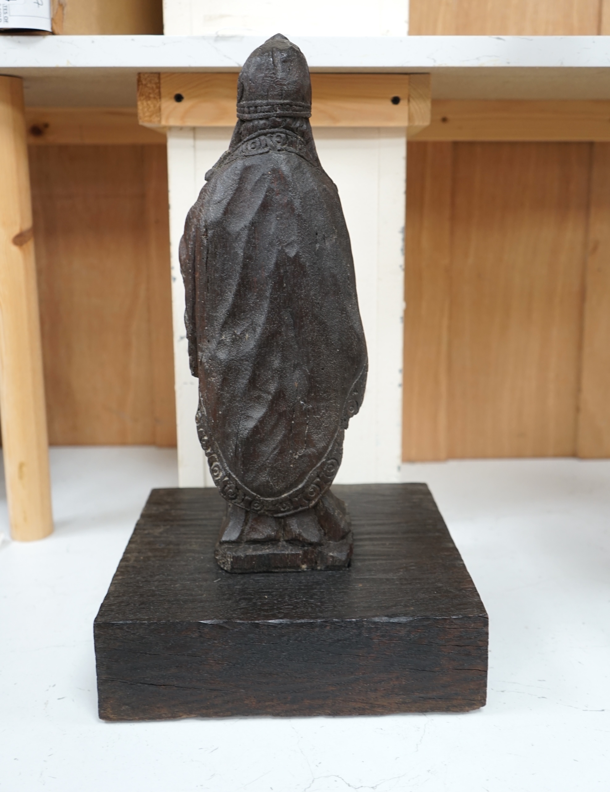 A North European oak carving of a bishop, possibly 17th/18th century, 38cm high not including stand. Condition - poor